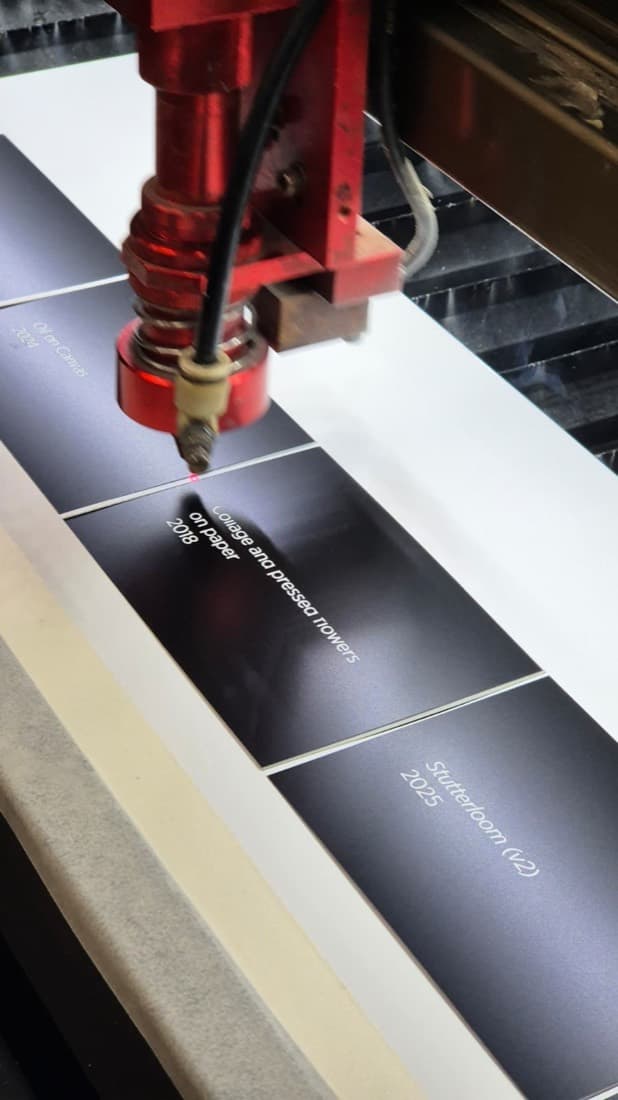 Laser engraving plaques and signage panels being cut on the laser bed